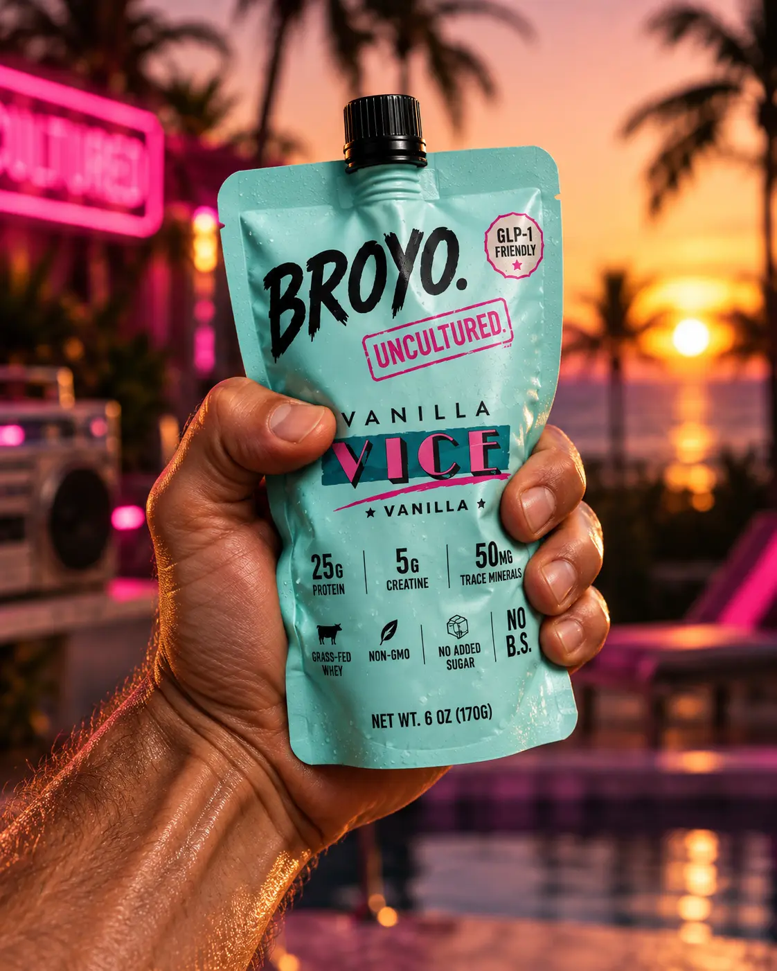 Broyo Vanilla Vice pouch in hand at a palm-lined sunset